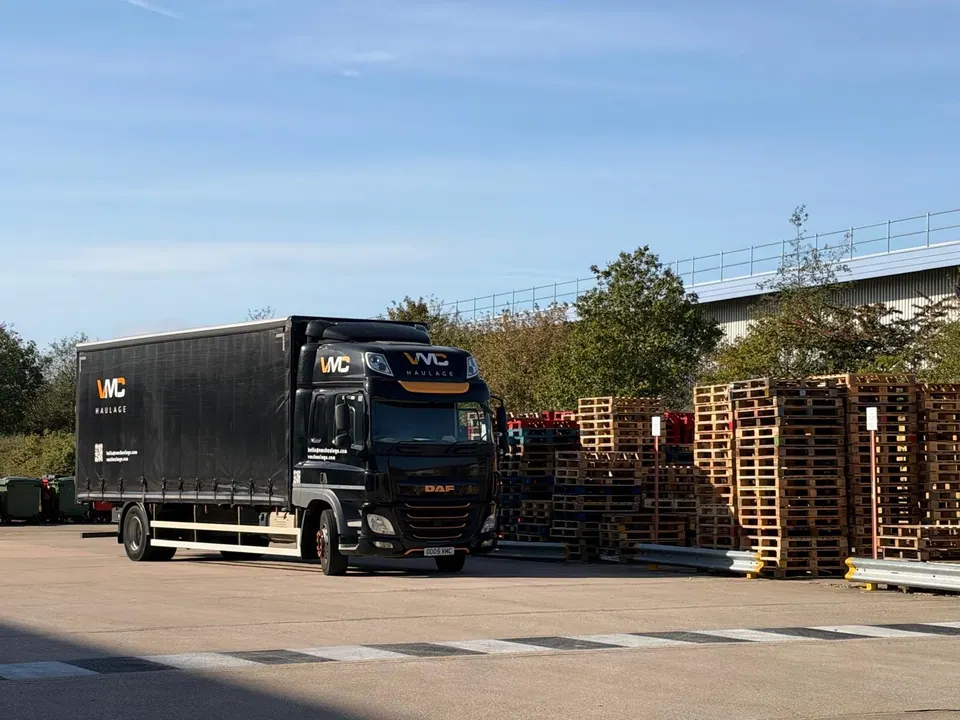 VMC Haulage lorry alongside stacked pallets.
